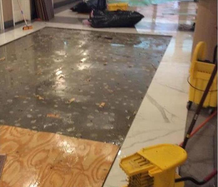 plywood on flooded surface in a lobby
