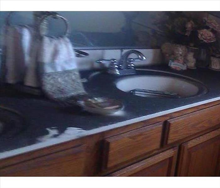 soot-covered vanity countertop and surfaces
