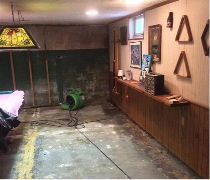  air mover and bare concrete pad in this basement man-cave