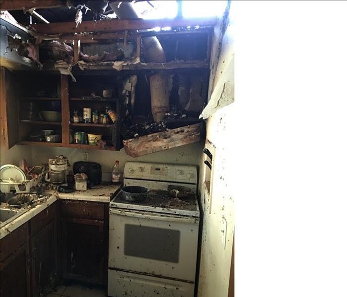hole in the roof, exhaust hood and kitchen destroyed by fire