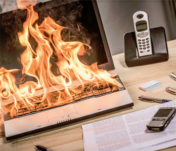 a computer on fire at a desk