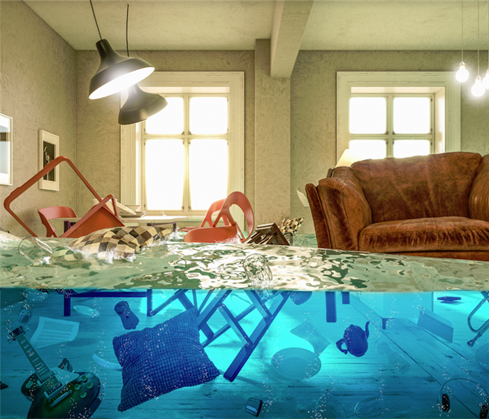 a flooded living room with furniture and items floating everywhere